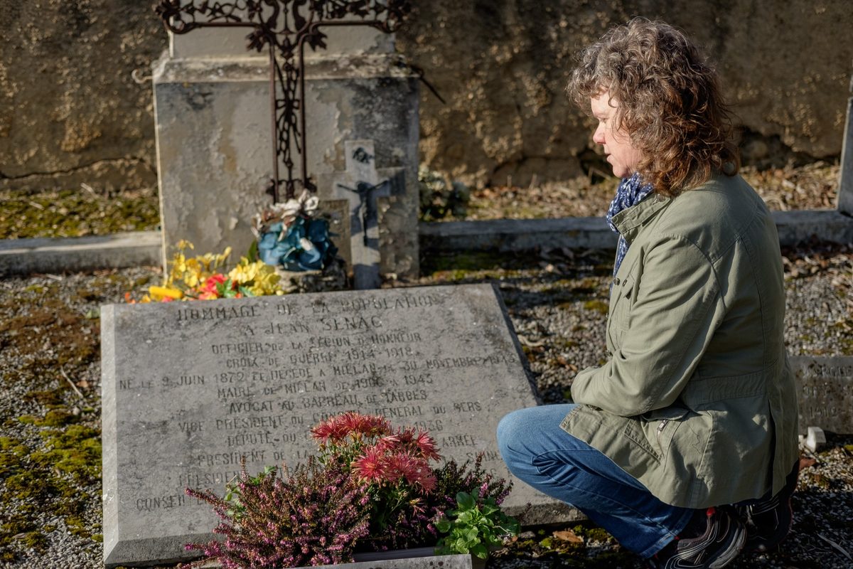 Linda Hammond examining a historic gravestone as part of genealogical research